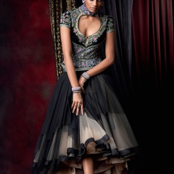 Asymmetrical froufrou tulle skirt in black and beige, worn with a sculpted blouse, embellished with Swarovski Elements